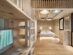 A wooden interior with bunk beds, a desk with a computer, and a bed with a headboard. - Cabin in Turrach With Sauna and Balcony (Stadl-Predlitz)