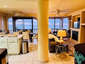 A spacious living area with a view of the ocean, a fireplace, and a dining area with a view. - Oceanfront Angel Villa with dipping pool, dog friendly and secure garage (B.C.)