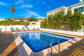 A swimming pool with a tiled deck, lounge chairs, and a pergola. - Luxury Villa With Jacuzzi and sea Views (Nerja)
