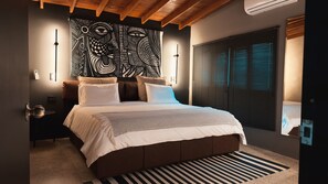 Ein modernes Schlafzimmer mit einem großen Bett, einem Wandbild und einem Fenster mit Jalousien.