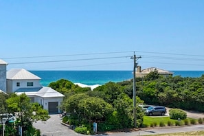 A coastal residential area with houses, a clear view of the ocean, and a paved road. - Seabreeze 30A (Panama City Beach)