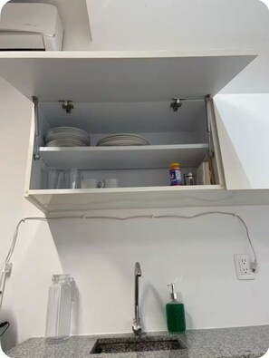 A kitchen with a built-in dishwasher, a sink with a faucet, and a countertop with a soap dispenser. - Loft Acapulco Diamante / Club de Playa / canchas (Acapulco de Juárez)