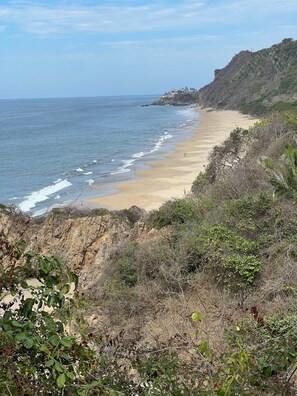 A coastal beach with a rocky cliff and sparse vegetation. - Private garden retreat 1-bedroom casita with AC in charming Sayulita (Sayulita)