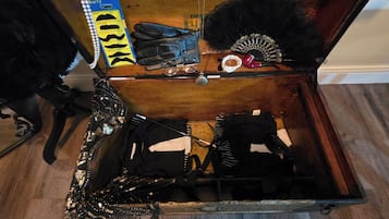An open trunk with various items inside, including a belt, a pair of gloves, and a decorative item.