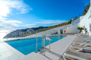 A swimming pool with a view of the sea and a hillside. - Apartment in Nerja With Panoramic Sea Views (Nerja)