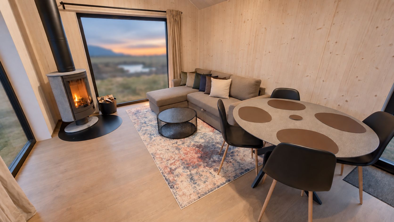 A modern living room with a sofa, round table, and a fireplace.