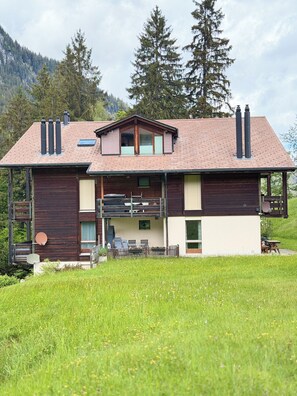 A two-story house with a balcony, a chimney, and a satellite dish. - Bijou makes your vacation magical. (Diemtigen)