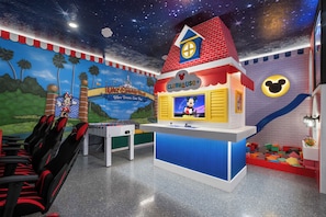 A children's play area with a foosball table, a Clubhouse+ play station, and a Mickey Mouse-themed wall. - NEW Disney Clubhouse & Themed BR I Near Clubhouse (Davenport)