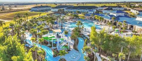 A resort with multiple swimming pools, a water park, and a large building complex.