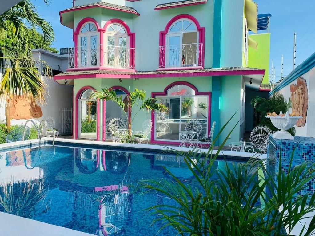 A multi-story building with a swimming pool in the foreground.
