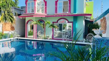 A multi-story building with a swimming pool in the foreground.