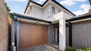 A modern two-story house with a garage, brick walls, and a clear sky. - Cuthbert Place Broadmeadows (Broadmeadows)
