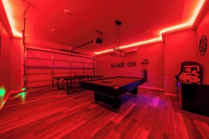 A room with a pool table, a ping pong table, and a wall with 'GAME ON' text. - Sleeps 24! 8 Bedrooms | Gameroom (Lake Hamilton)