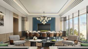 A modern dining area with a round table, multiple chairs, and a decorative chandelier.