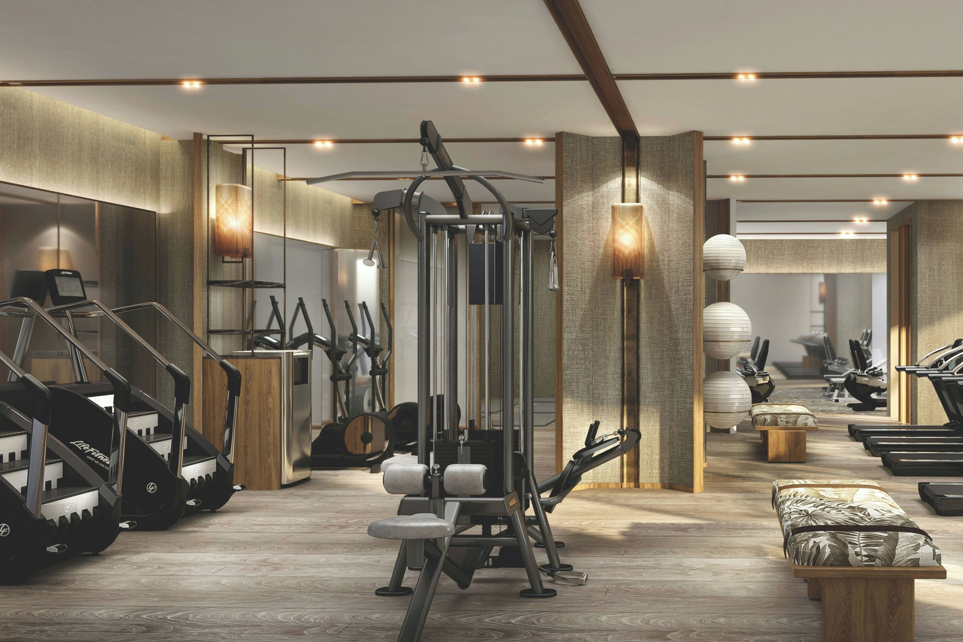 A modern gym with various exercise equipment, including treadmills and weight machines.