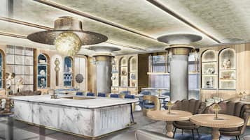 A spacious hotel lobby with a marble reception desk, seating areas, and decorative lighting.