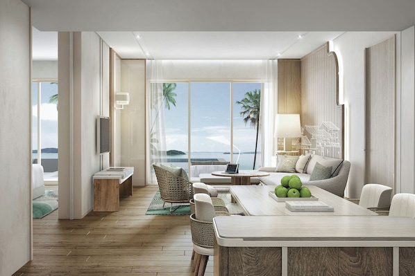 A modern hotel room with a wooden floor, a dining area with a table and chairs, a sofa, a TV, and a view of the sea.