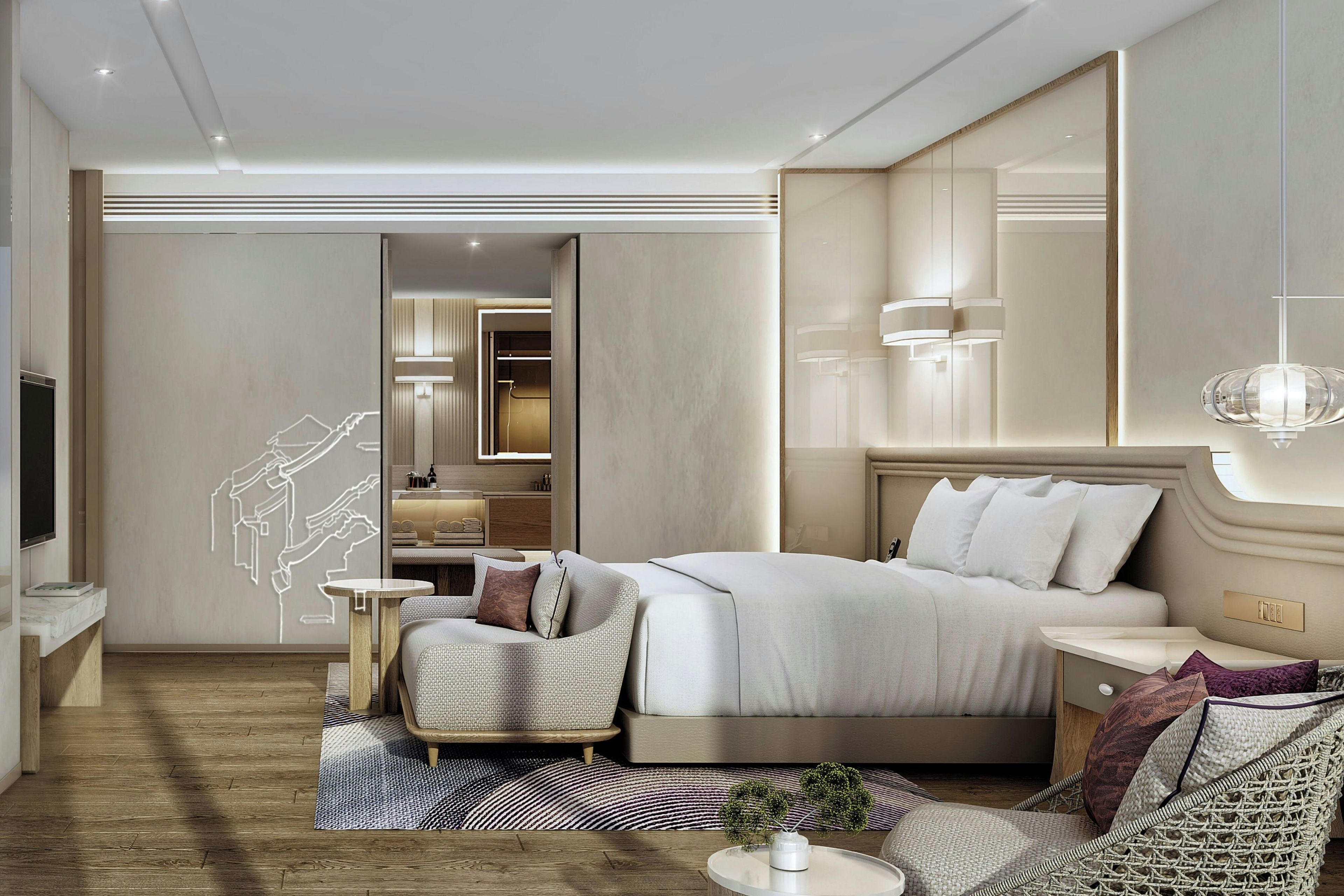 A modern hotel room with a large bed, a seating area, a vanity, and a large mirror.