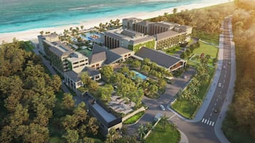 A resort with multiple buildings, a swimming pool, and a beach.