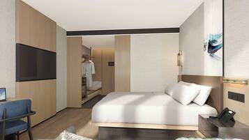 A modern hotel room with a bed, a desk, a chair, and a TV.