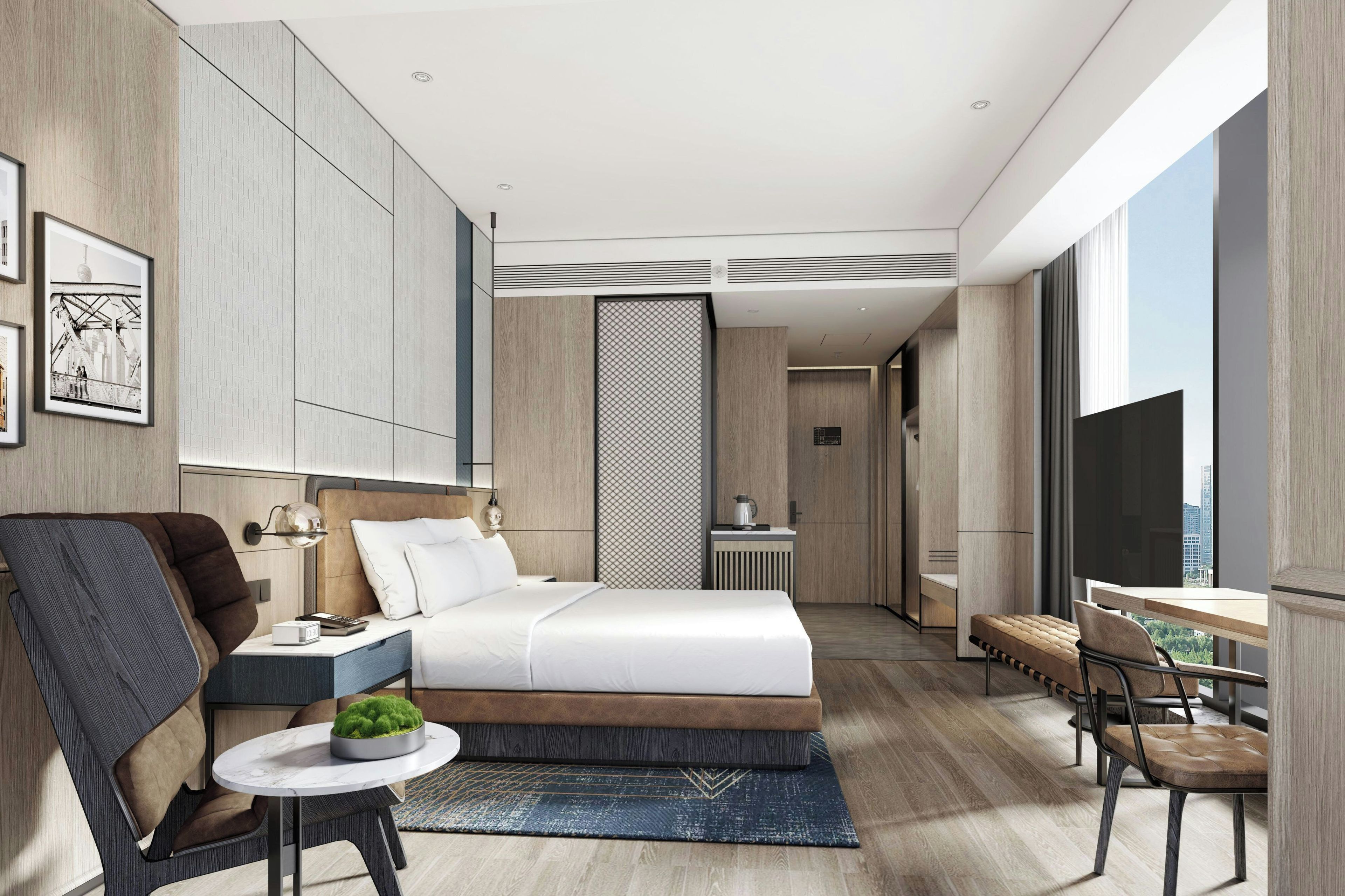 A modern hotel room with a bed, bedside table, lamp, chair, desk, and a large window.