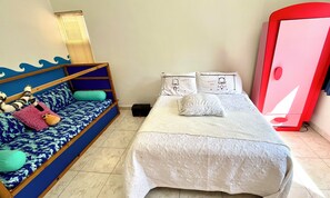 A bedroom with a bed, a sofa, a wardrobe, and a window with blinds. - Casa Corazon: a tropical boutique villa by the golf course, with a pool and a nearby beach (puerto aventuras)