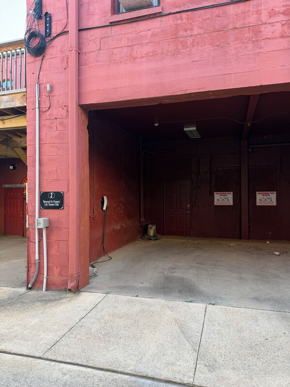 A red building with a sign indicating it is reserved for project tenants only.