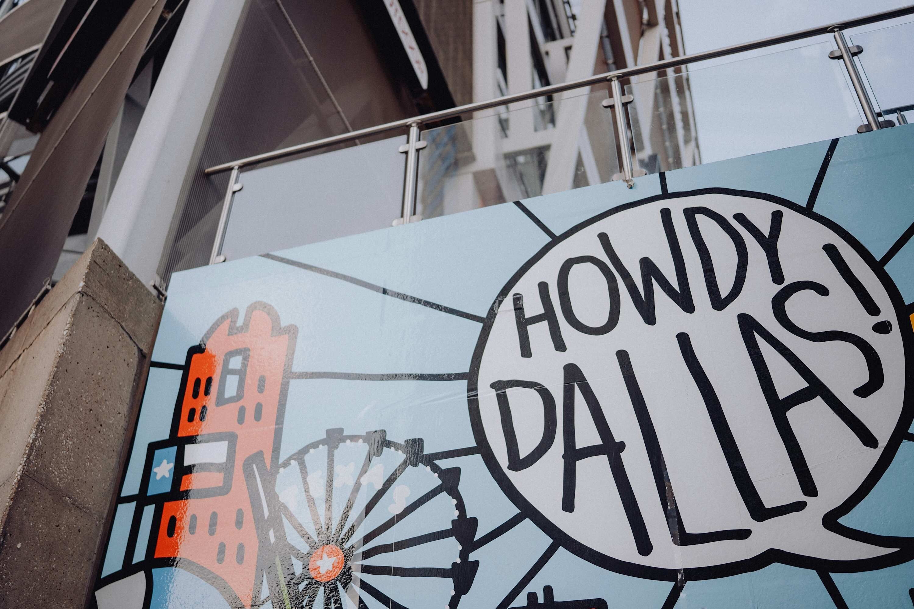 A sign with 'HOWDY! DALLAS!' text and a stylized cityscape.