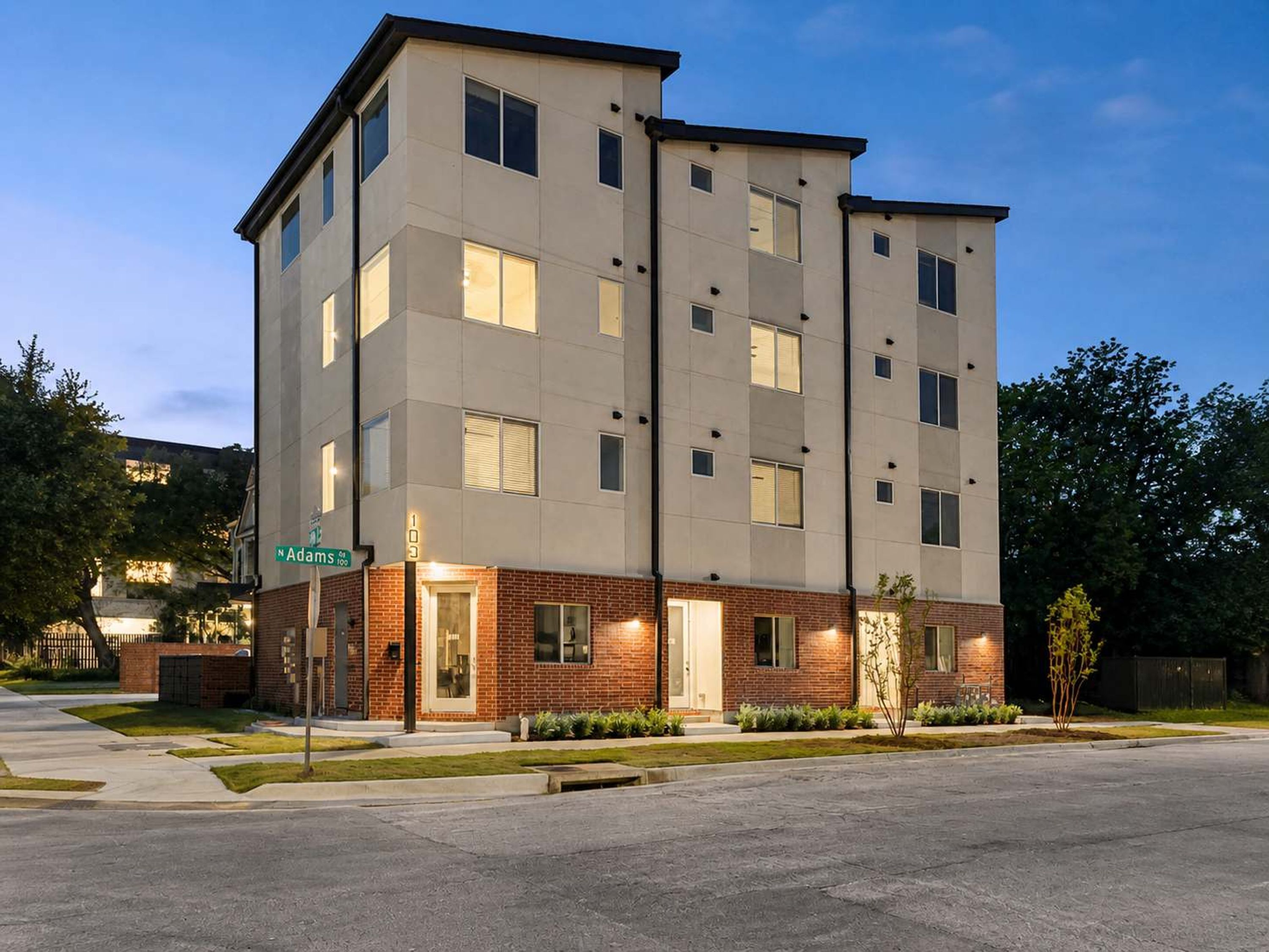 A multi-story hotel with a brick facade and multiple windows.