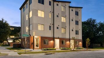 A multi-story hotel with a brick facade and multiple windows.