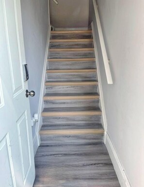 A staircase with wooden steps and white handrails. - Modern & Private 1-Bedroom Apartment (Windsor)