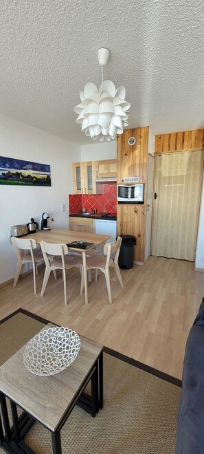 A compact kitchen with wooden cabinets, a microwave, and a coffee maker. - 2-STAR STUDIO FOR 4 PEOPLE AT THE FOOT OF THE SLOPES. Housekeeping. Weekends and staggered work weeks available upon request. (Saint-Sorlin-d'Arves)