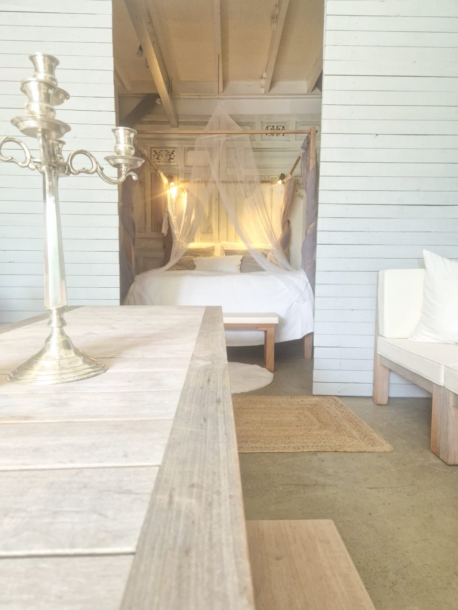 Une chambre à coucher avec un lit, une table de chevet, une chaise et un lit à baldaquin.