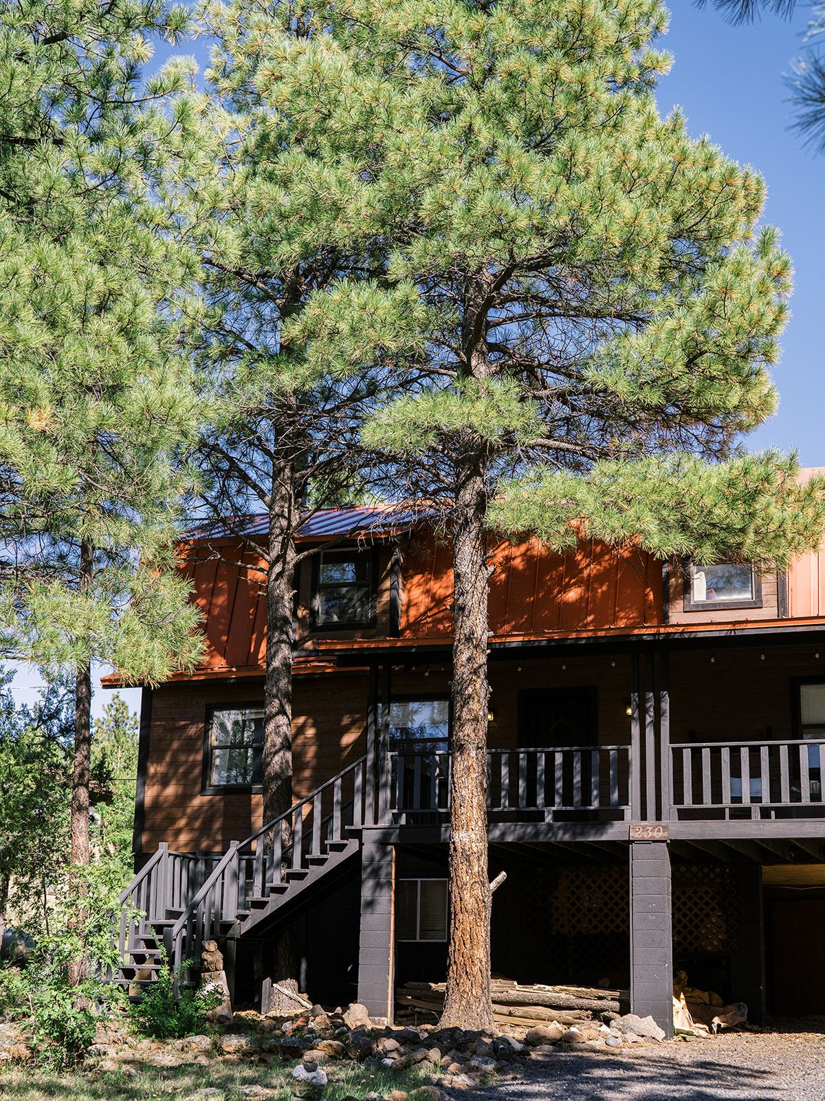 A two-story building with a wooden staircase leading to a balcony.