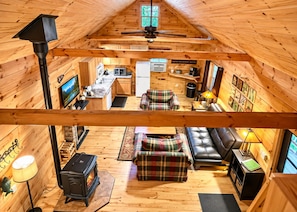 A cozy cabin interior with a fireplace, a sofa, a dining area, and a kitchen. - Hatfield Cabin, Lake Arbutus Beach & Campground Steps Away, Fire Pit, Golf Cart (Merrillan)