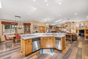 A spacious kitchen with a central island, wooden cabinetry, and stainless steel appliances. - Luxury Estate with Indoor heated Pool, Spa & Casita (Flagstaff)