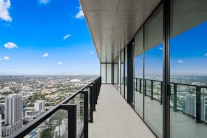 A high-rise building with a glass balcony overlooking a cityscape. - Luxury Sky Penthouse Panoramic Views Rooftop Pool (Miami)