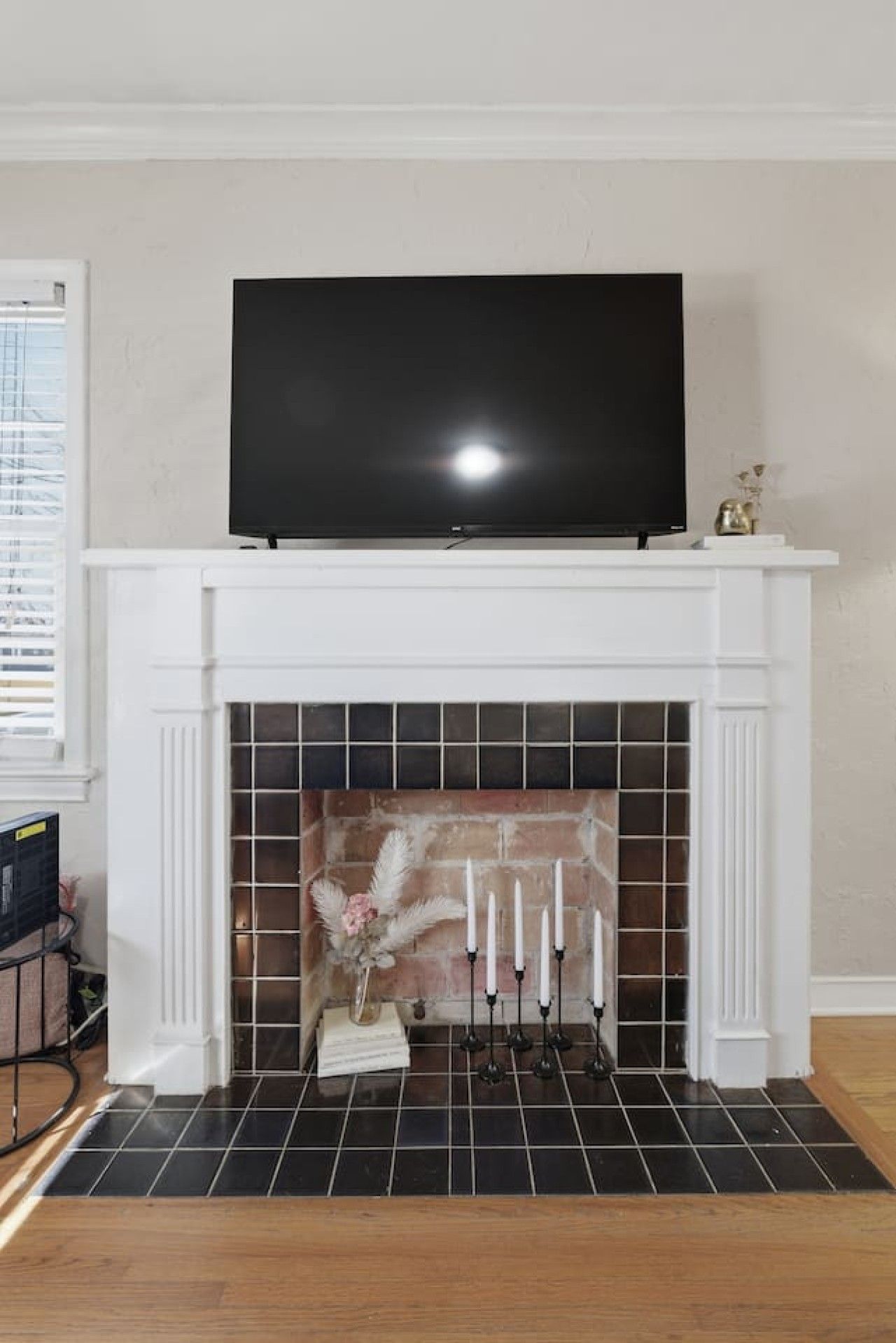 A fireplace with a flat-screen TV mounted above it.