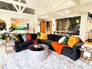 A modern living room with a sectional sofa, a coffee table, and a patterned rug. - McLaren Vale Vineyard Loft | Full Kitchen + Bath (Blewitt Springs)