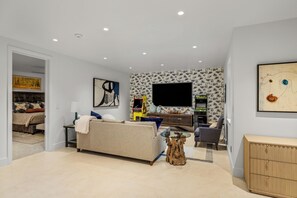 A modern living room with a sofa, a coffee table, and a television. - French Point Ridge! Elegant, Brand New Single Family Home, Amazing! (Steamboat Springs)
