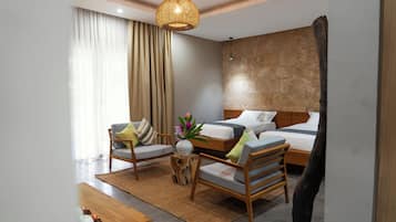 A modern hotel room with a bed, two chairs, a small table, and a decorative vase.