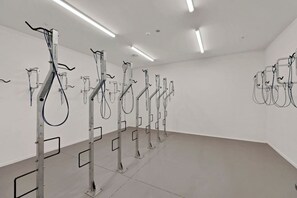 A room with a series of wall-mounted exercise equipment. - Boutique CBD Apartment — Walk to Everything (Christchurch)