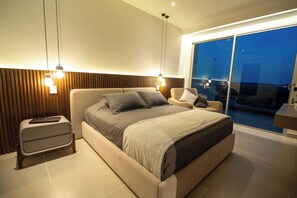 A modern bedroom with a large bed, bedside tables, and a view of the outside. - Luxury 3-Bedroom Penthouse  Crystal Lagoon & White-Sand Beach (Cartagena de indias)