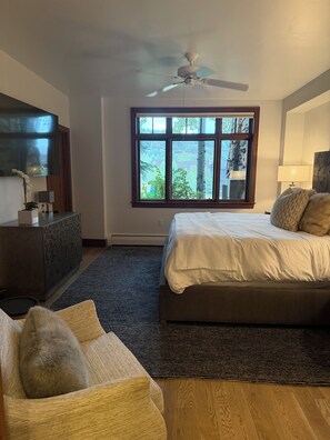 A bedroom with a bed, a dresser, a TV, a window, and a ceiling fan. - Snow Cloud Slope Side Dream
3 bedroom/3 1/2 bath ski in/ski out (Avon)