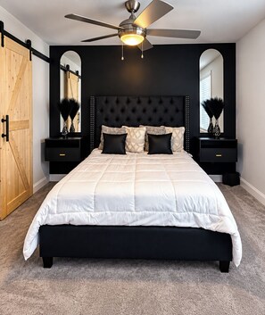 A bedroom with a bed, a ceiling fan, and two nightstands with lamps. -     Luxury 2BR Summerville Retreat / Modern, Cozy & Close to Everything (Summerville)