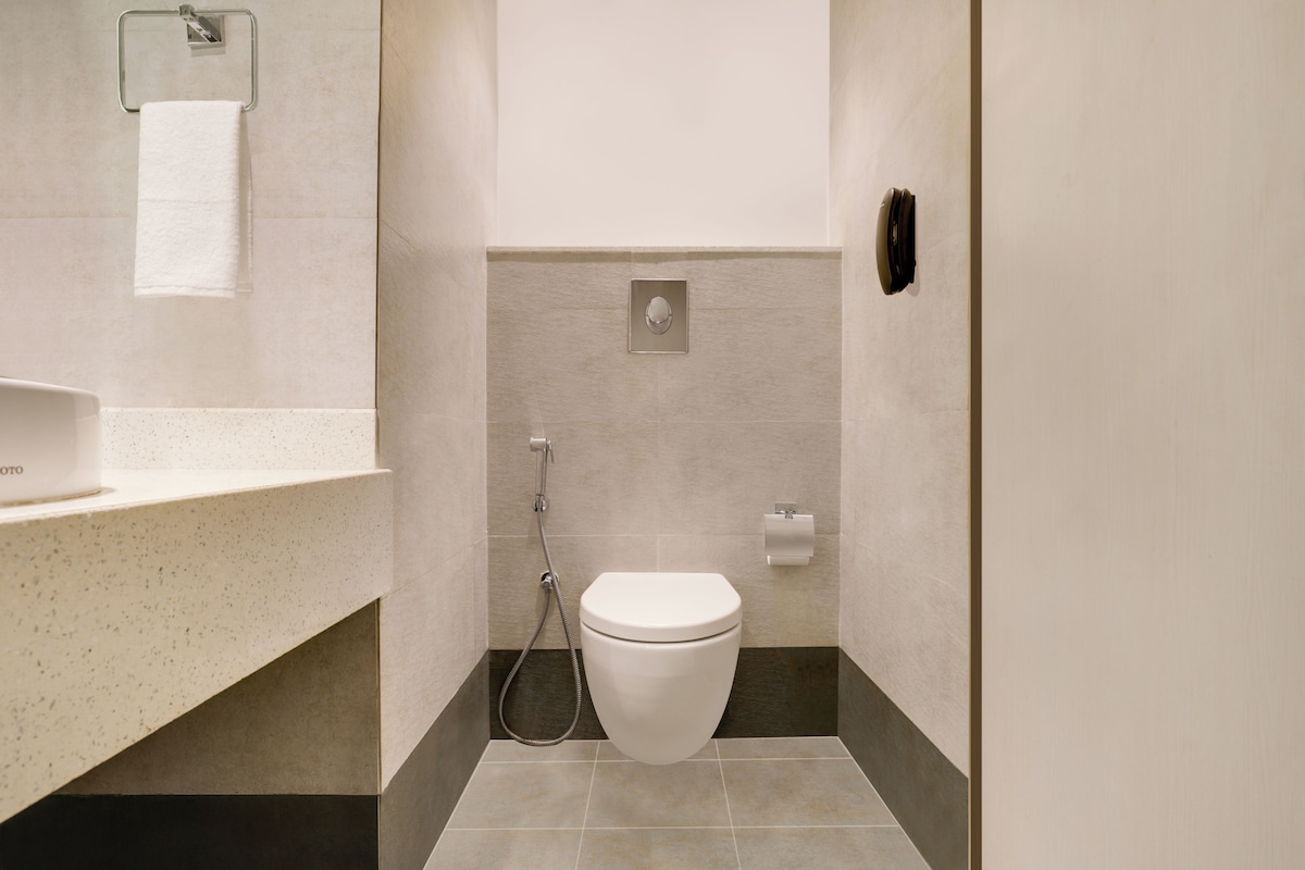 Un baño moderno con inodoro, ducha y lavamanos.