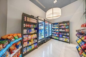A grocery store with refrigerated sections and shelves stocked with various products. - Modern Miami 2BR Suite | Sleeps 4 | Pool & Gym (Miami)