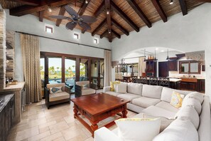 A spacious living area with a large sofa, a wooden coffee table, and a ceiling fan. - Luxury Palmilla Golf 4BR Villa w/ Pool & Jacuzzi (San José del Cabo)