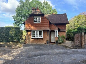 A two-story brick house with a pitched roof and a front porch. - Hampshire Cottage in Hartley Wintney (Hartley Wintney)