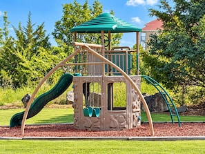 A playground with a slide, climbing area, and a covered playhouse. - Four Kings and Four Baths, Your Retreat by the Strip (Branson)